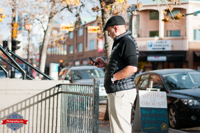YYC street photography kensington coffee shop guy man phone - Rob Moses Photography - Vancouver Seattle Calgary Photographer Photographers Native American Famous Tlingit Ojibawa Top Popular Best Good Canadian Awesome Lifestyle
