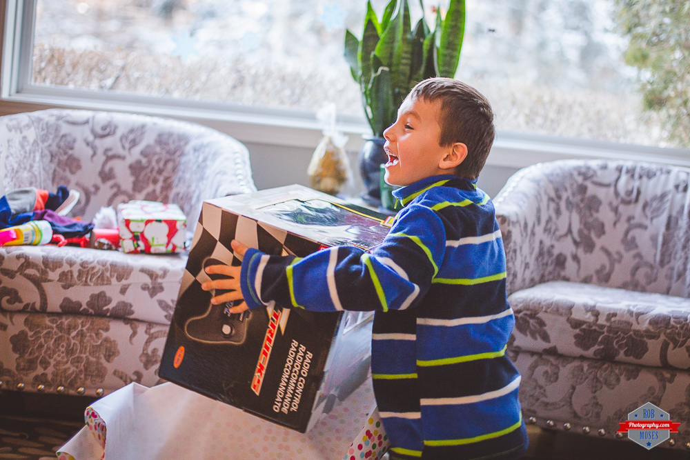 Christmas 2015 boy openning gift happy Rob Moses Photography Calgary Vancouver Seattle Spokane Photographer WA BC Native American Tlingit Ojibaway famous un celebrity Canadian best 1